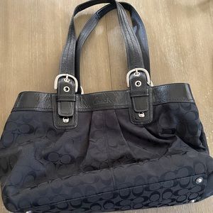 Elevate your style with this black Coach purse in good condition inside/out!